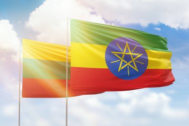 Sunny blue sky and flags of ethiopia and lithuania