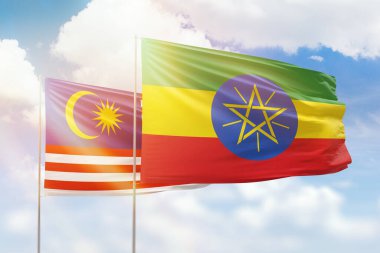 Sunny blue sky and flags of ethiopia and malaysia