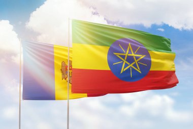 Sunny blue sky and flags of ethiopia and moldova