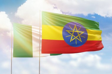Sunny blue sky and flags of ethiopia and nigeria