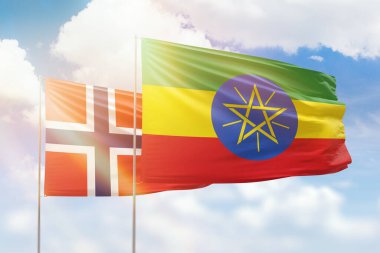 Sunny blue sky and flags of ethiopia and norway