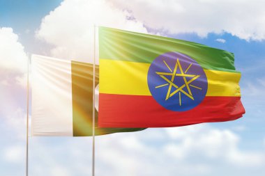 Sunny blue sky and flags of ethiopia and pakistan