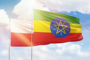 Sunny blue sky and flags of ethiopia and poland