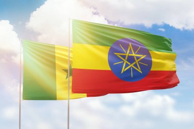 Sunny blue sky and flags of ethiopia and senegal