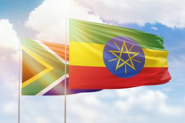 Sunny blue sky and flags of ethiopia and south africa