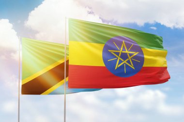 Sunny blue sky and flags of ethiopia and tanzania