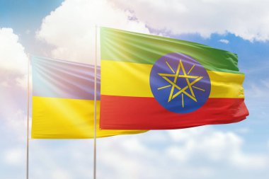 Sunny blue sky and flags of ethiopia and ukraine