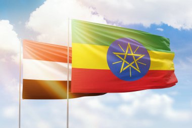 Sunny blue sky and flags of ethiopia and yemen