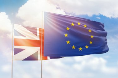 Sunny blue sky and flags of european union and great britain