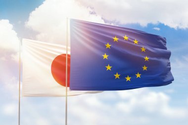 Sunny blue sky and flags of european union and japan