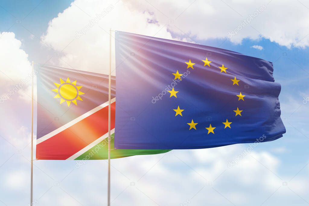 Sunny blue sky and flags of european union and namibia