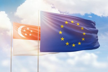 Sunny blue sky and flags of european union and singapore
