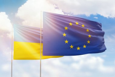 Sunny blue sky and flags of european union and ukraine