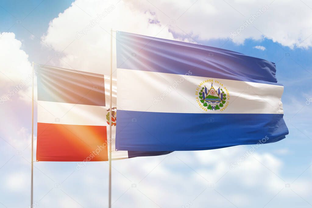 Sunny blue sky and flags of el salvador and dominican republic