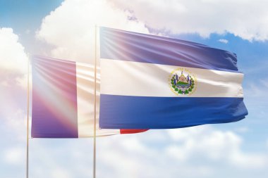 Sunny blue sky and flags of el salvador and france