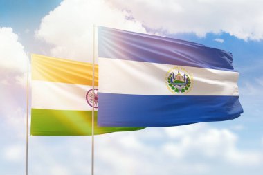 Sunny blue sky and flags of el salvador and india