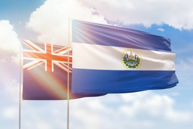 Sunny blue sky and flags of el salvador and new zealand