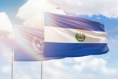Sunny blue sky and flags of el salvador and united nations