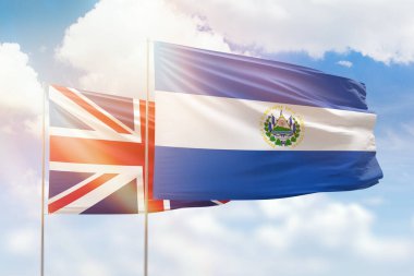 Sunny blue sky and flags of el salvador and united kingdom