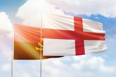 Sunny blue sky and flags of england and angola