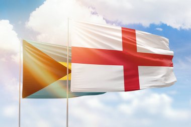 Sunny blue sky and flags of england and bahamas