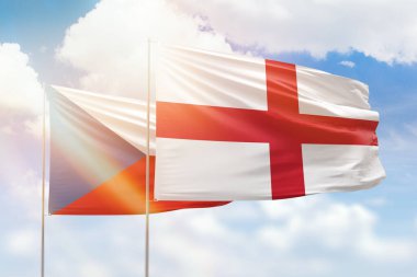 Sunny blue sky and flags of england and czechia
