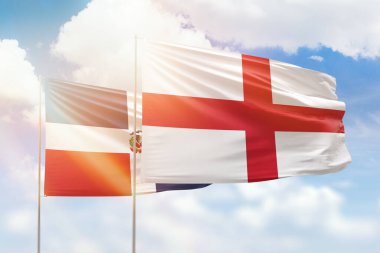 Sunny blue sky and flags of england and dominican republic