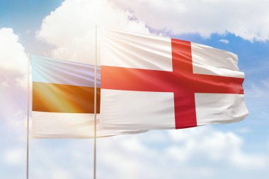 Sunny blue sky and flags of england and estonia