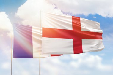 Sunny blue sky and flags of england and france