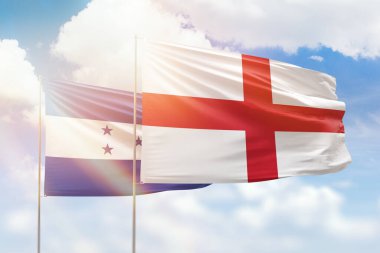 Sunny blue sky and flags of england and honduras