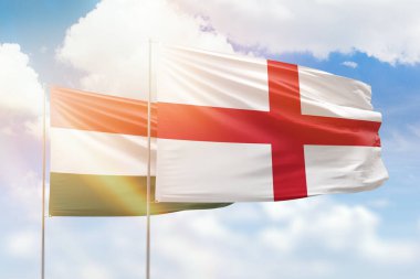 Sunny blue sky and flags of england and hungary