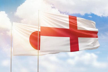 Sunny blue sky and flags of england and japan