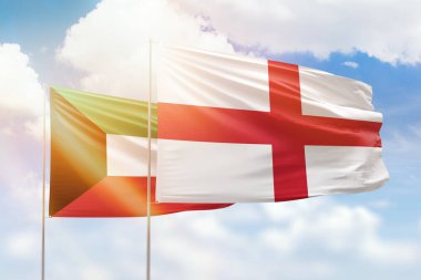 Sunny blue sky and flags of england and kuwait