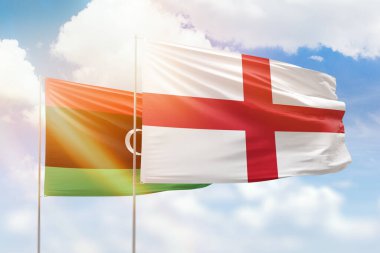 Sunny blue sky and flags of england and libya