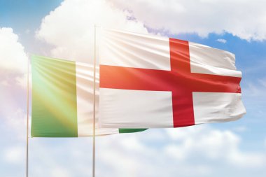 Sunny blue sky and flags of england and nigeria