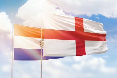 Sunny blue sky and flags of england and paraguay