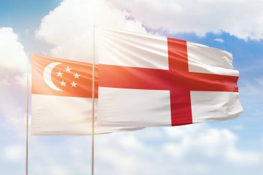 Sunny blue sky and flags of england and singapore