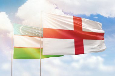 Sunny blue sky and flags of england and uzbekistan