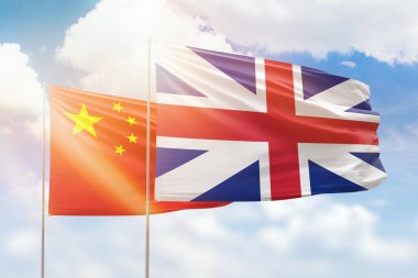 Sunny blue sky and flags of great britain and china