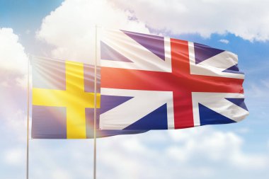Sunny blue sky and flags of great britain and sweden