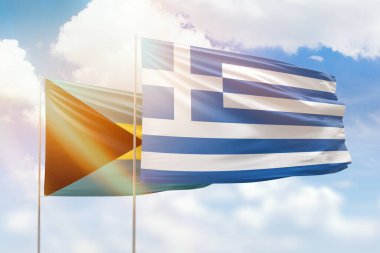 Sunny blue sky and flags of greece and bahamas