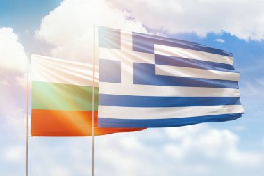 Sunny blue sky and flags of greece and bulgaria