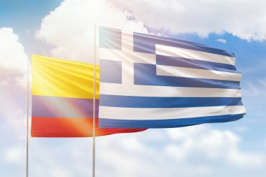 Sunny blue sky and flags of greece and colombia