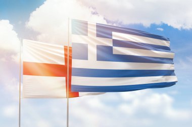 Sunny blue sky and flags of greece and england