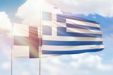 Sunny blue sky and flags of greece and finland