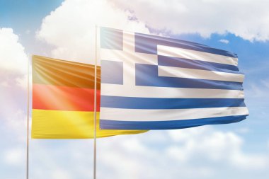 Sunny blue sky and flags of greece and germany