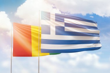 Sunny blue sky and flags of greece and guinea