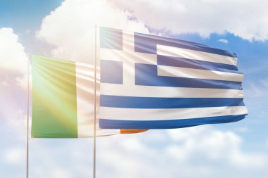 Sunny blue sky and flags of greece and ireland