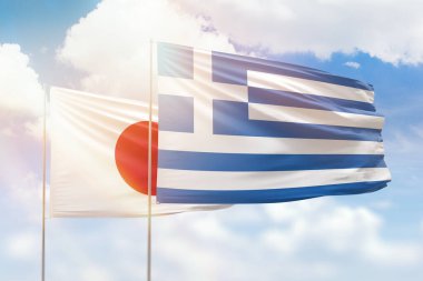 Sunny blue sky and flags of greece and japan