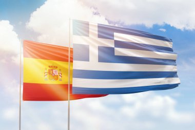 Sunny blue sky and flags of greece and spain